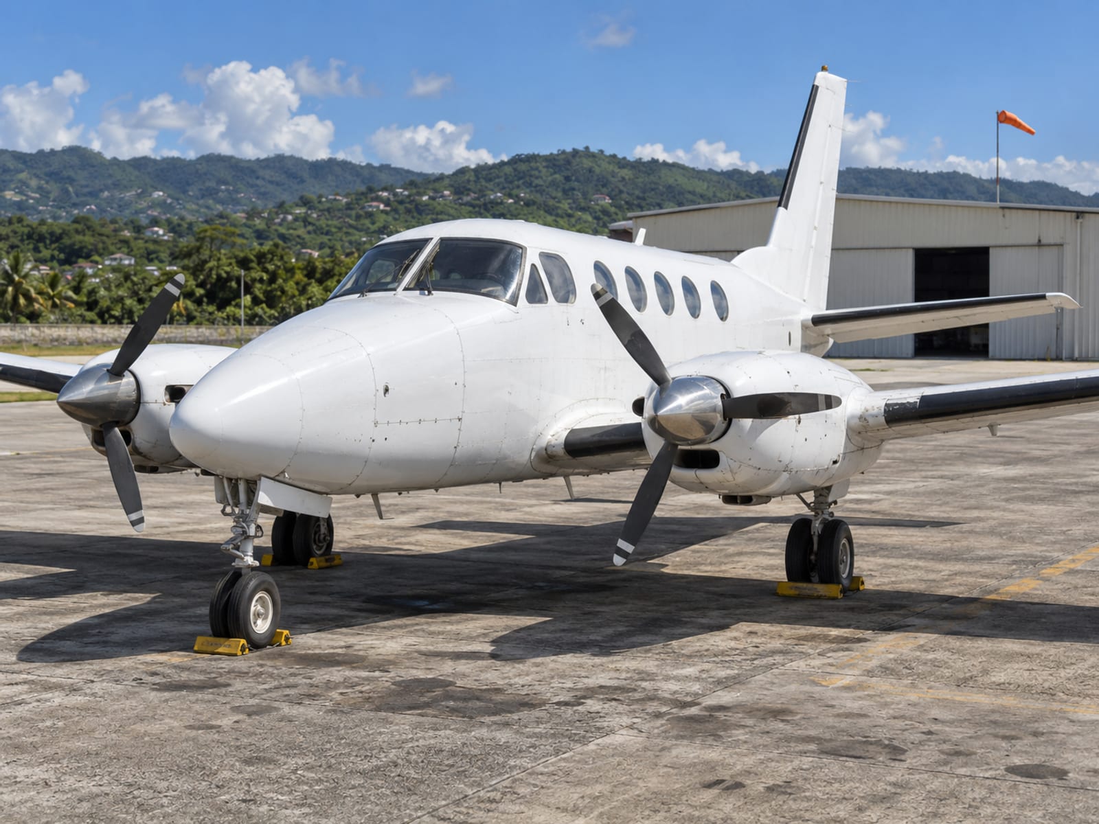 A small propeller aircraft parked on an airport apron