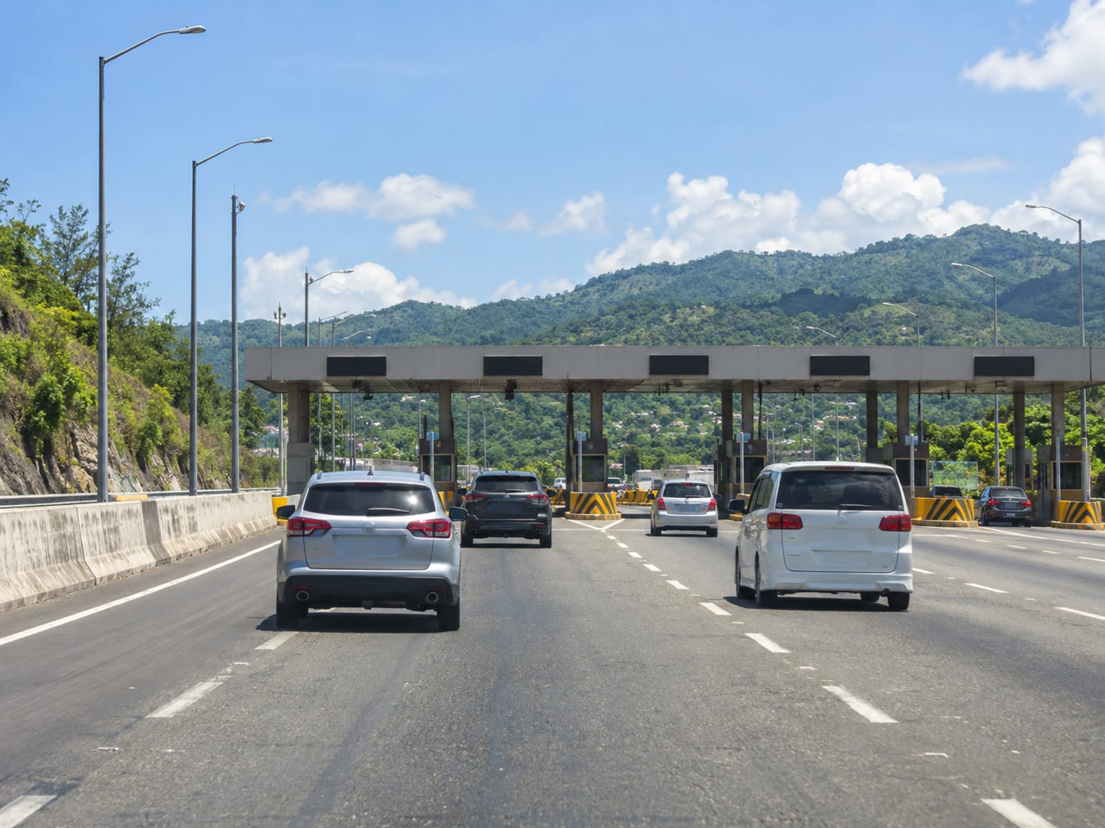A multi-lane highway with a toll plaza ahead