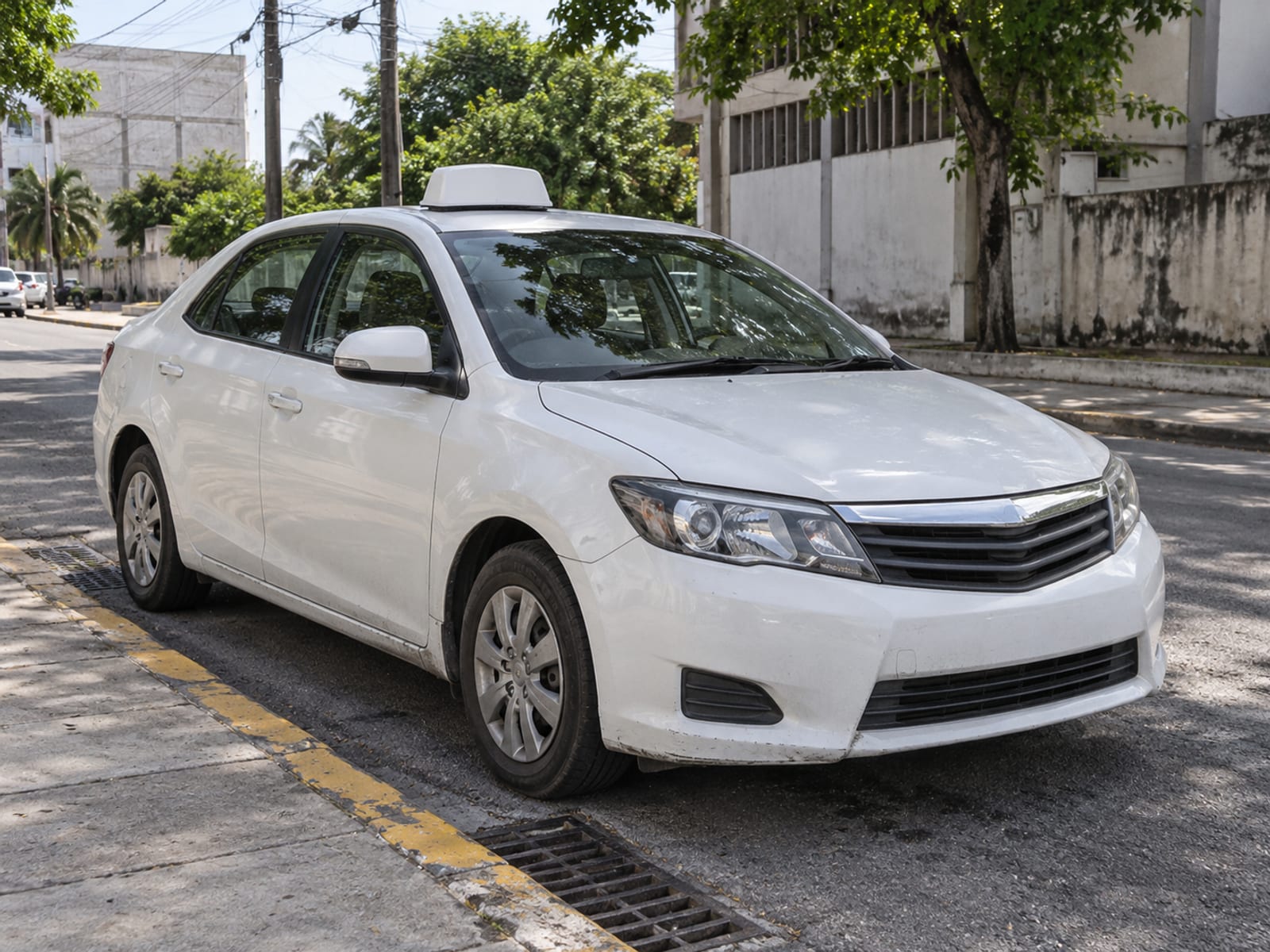 A taxi with a roof sign parked on a city street