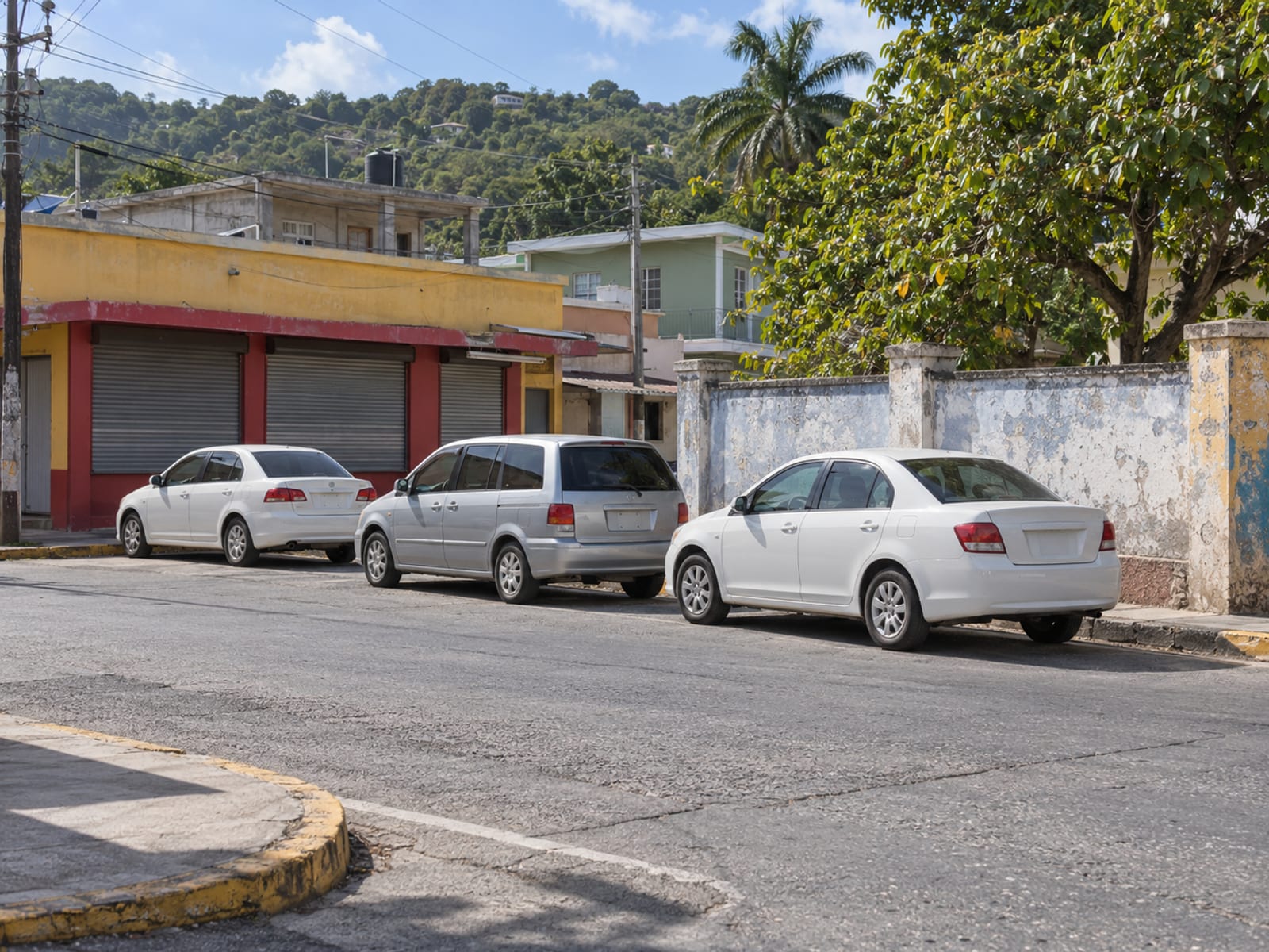 A road junction in a small Jamaican town with parked taxis