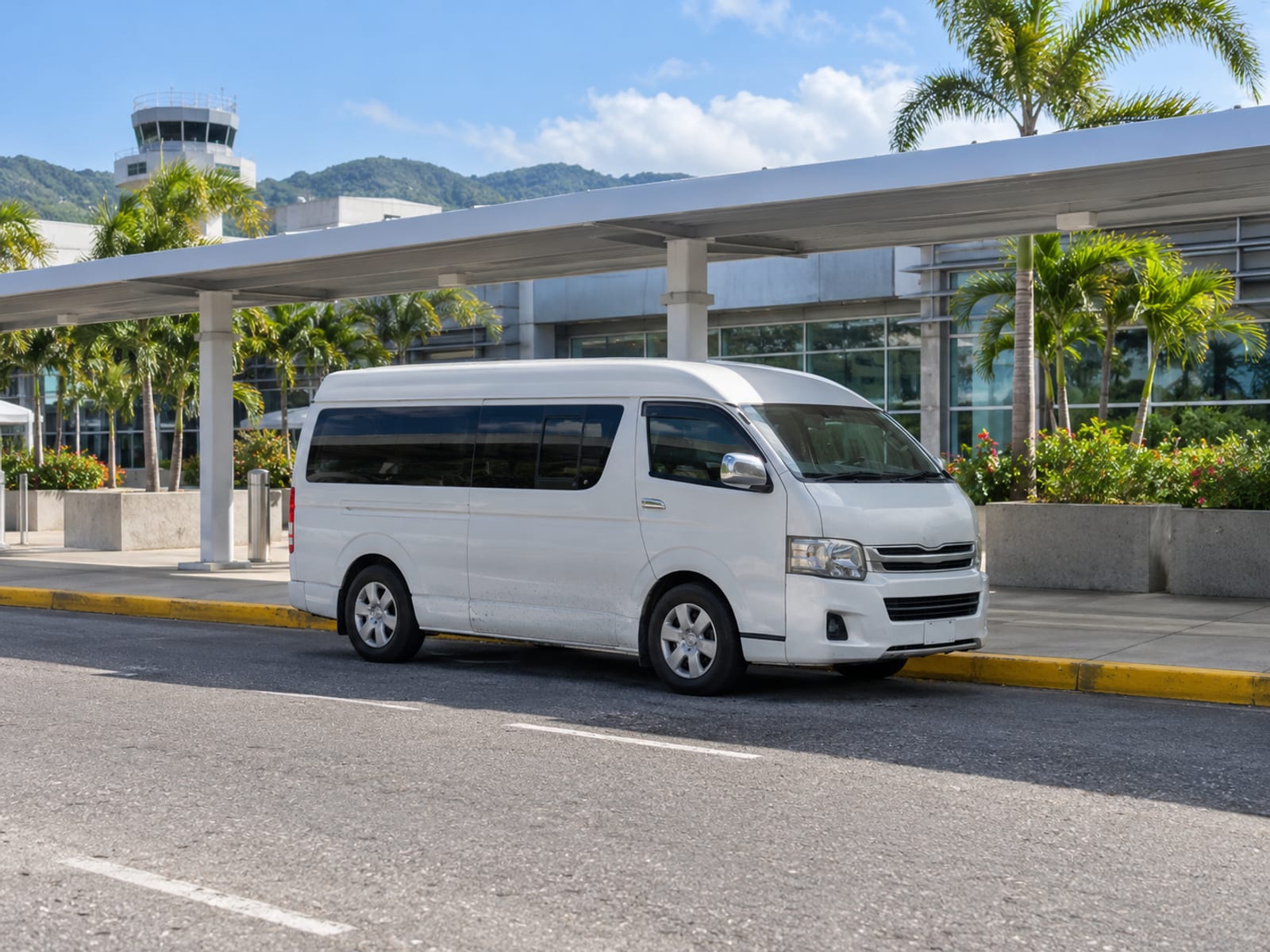 A plain minivan waiting at an airport pickup area