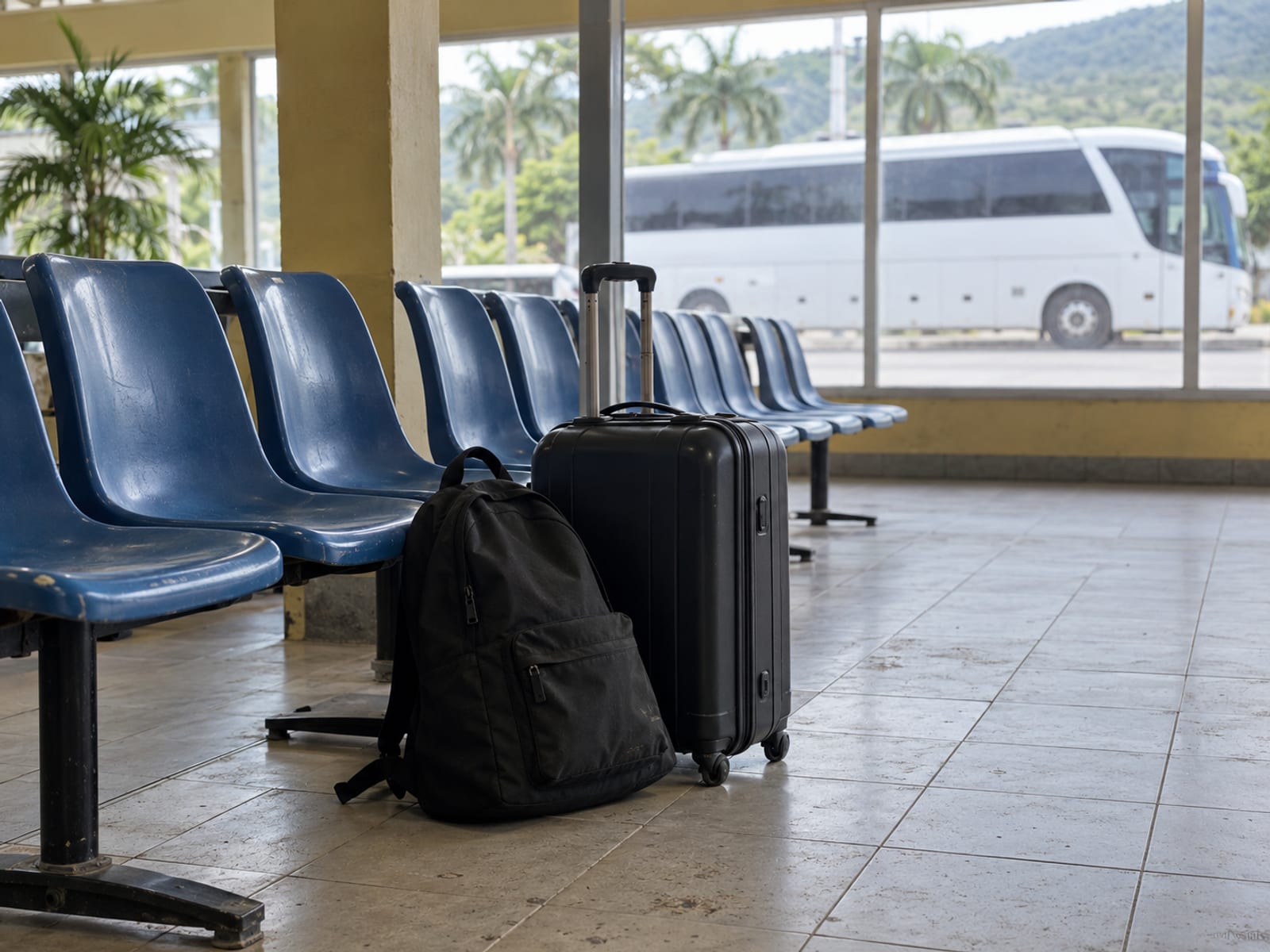 A waiting area at a bus terminal with luggage on the floor