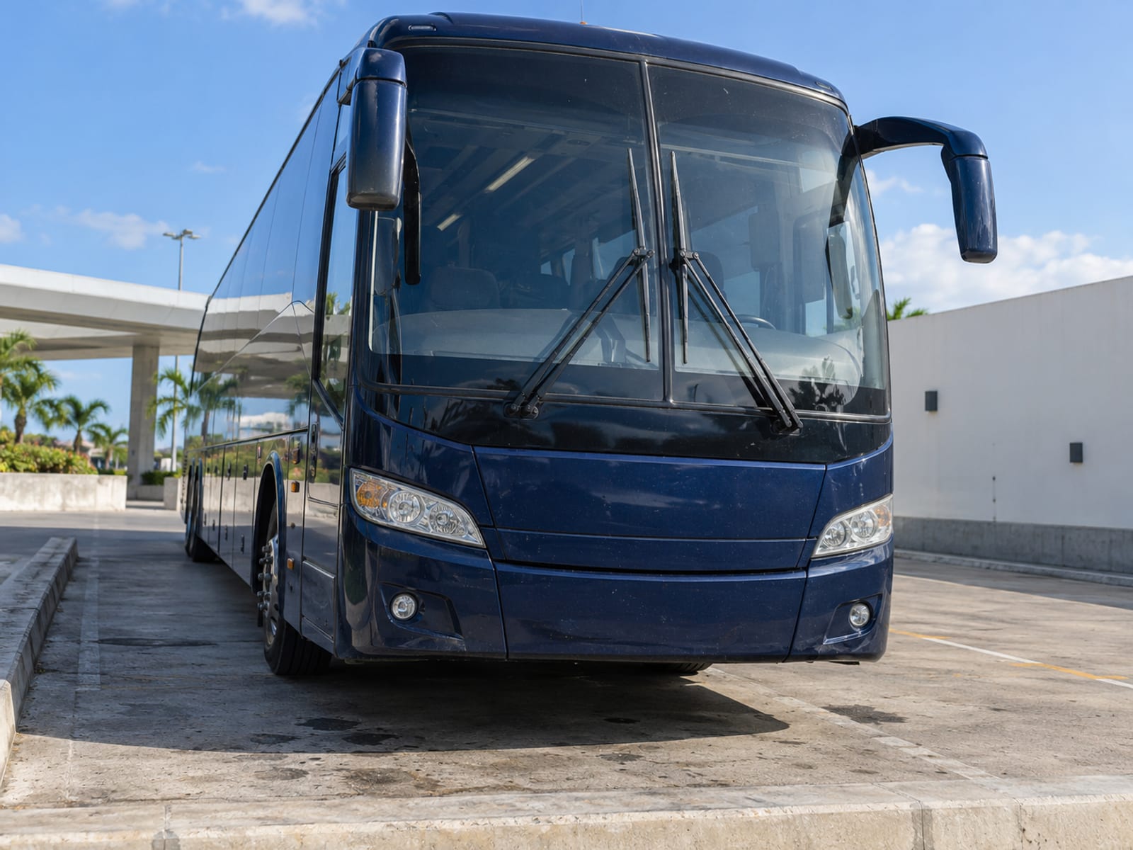 A long-distance coach parked at a terminal bay in daylight