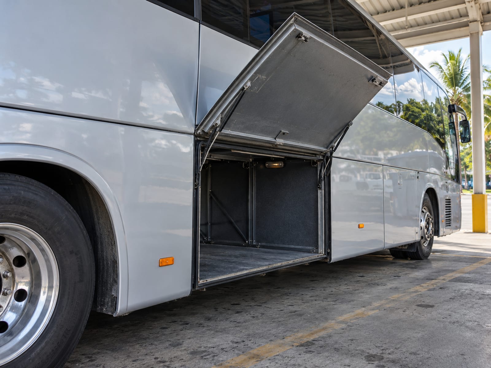 A coach at a terminal bay with its luggage hold open