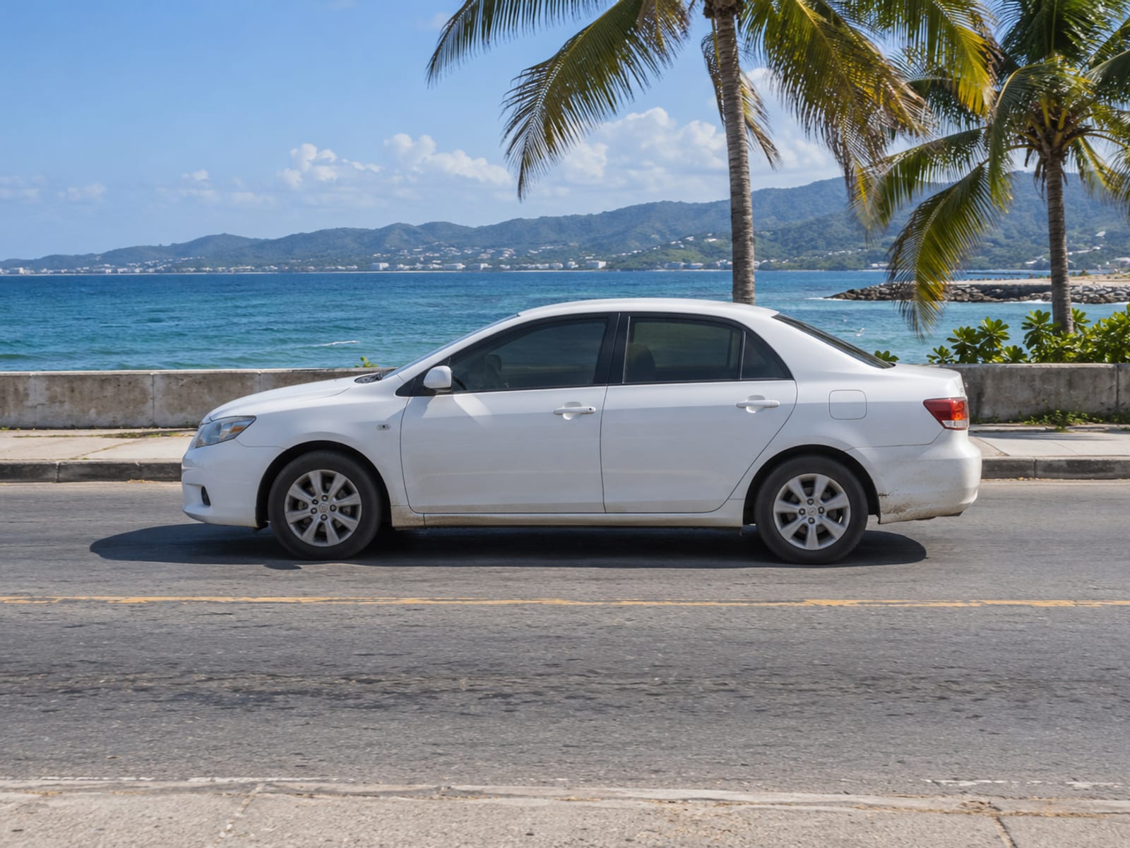 A taxi driving along a seafront road in Montego Bay