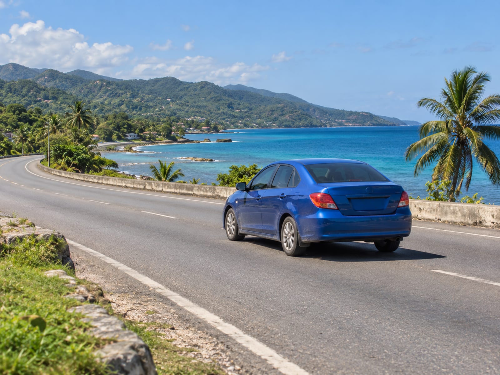 A car driving along a coastal highway in Jamaica