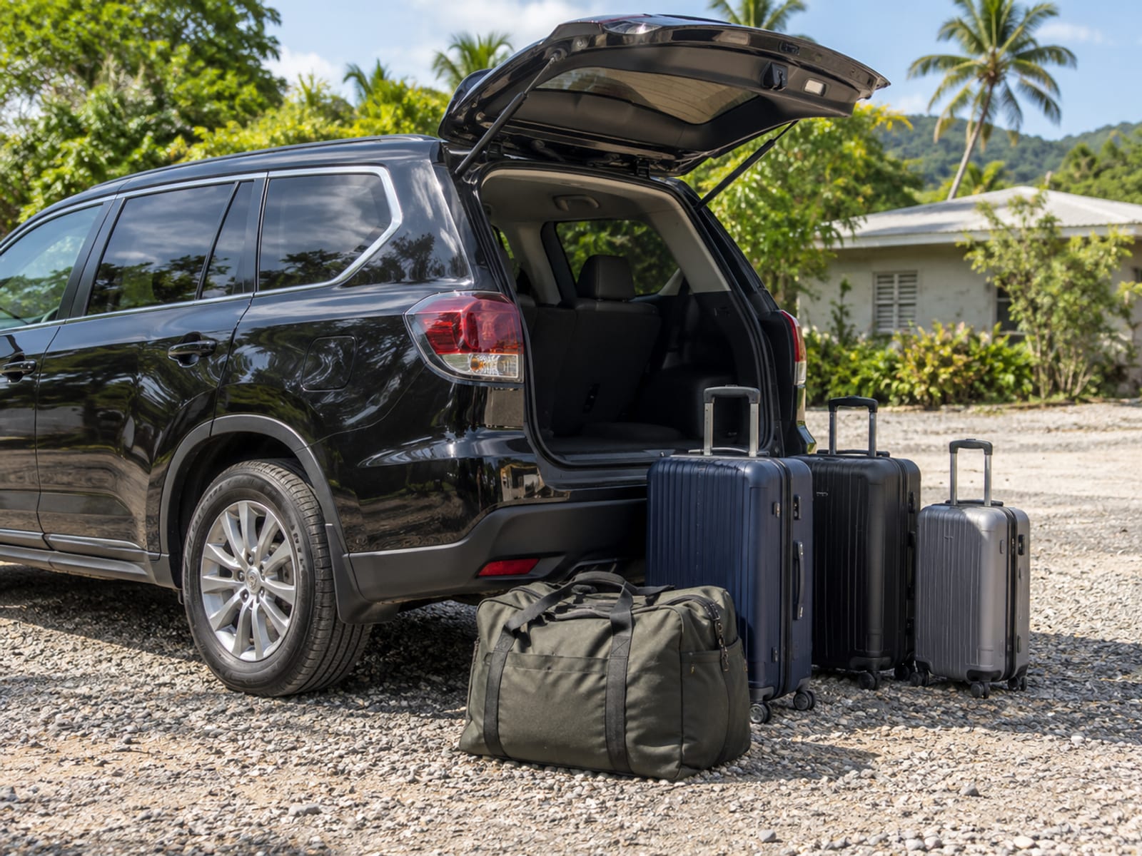 Luggage beside a car ready to be loaded