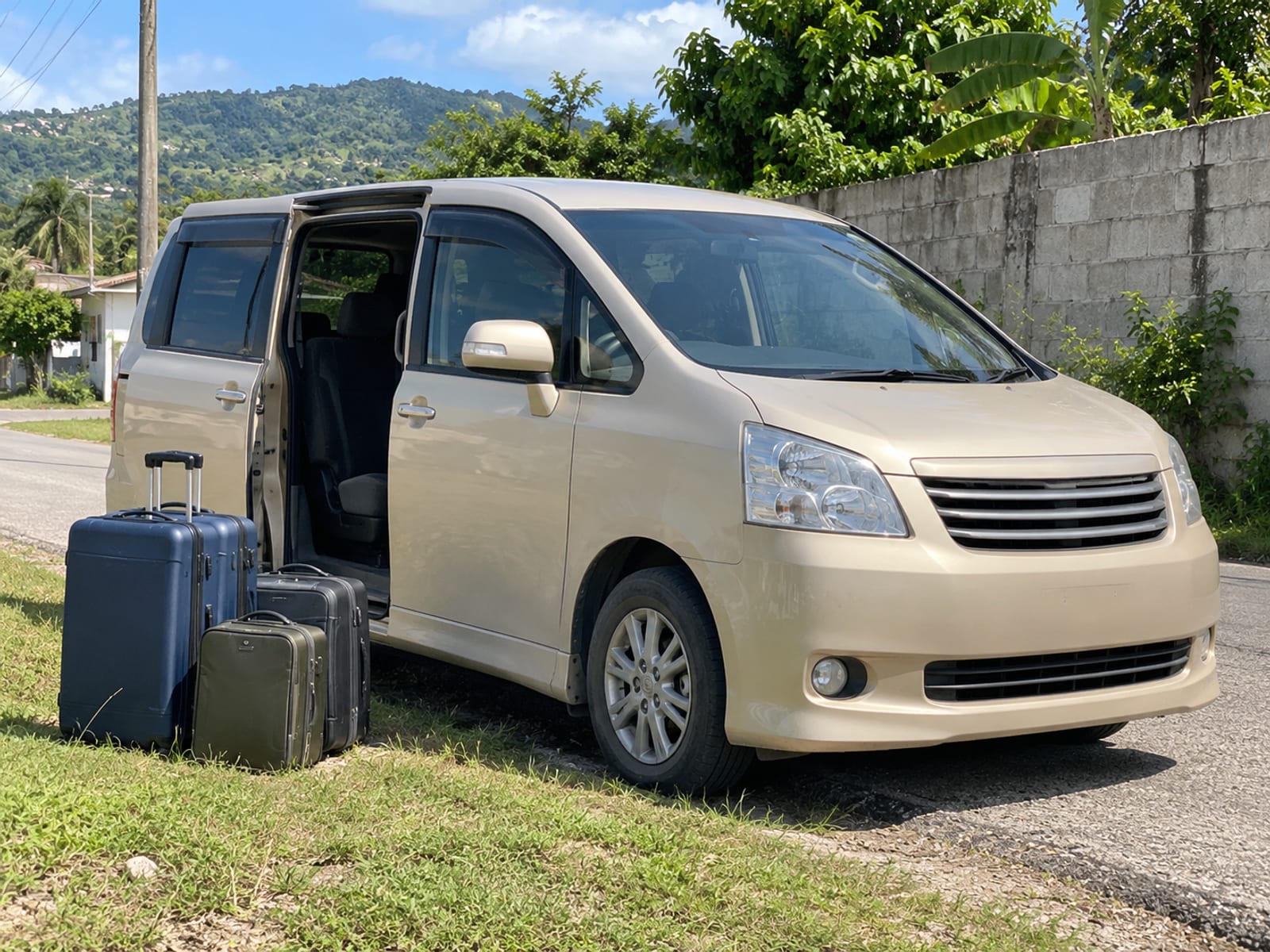 Luggage beside a car ready to be loaded