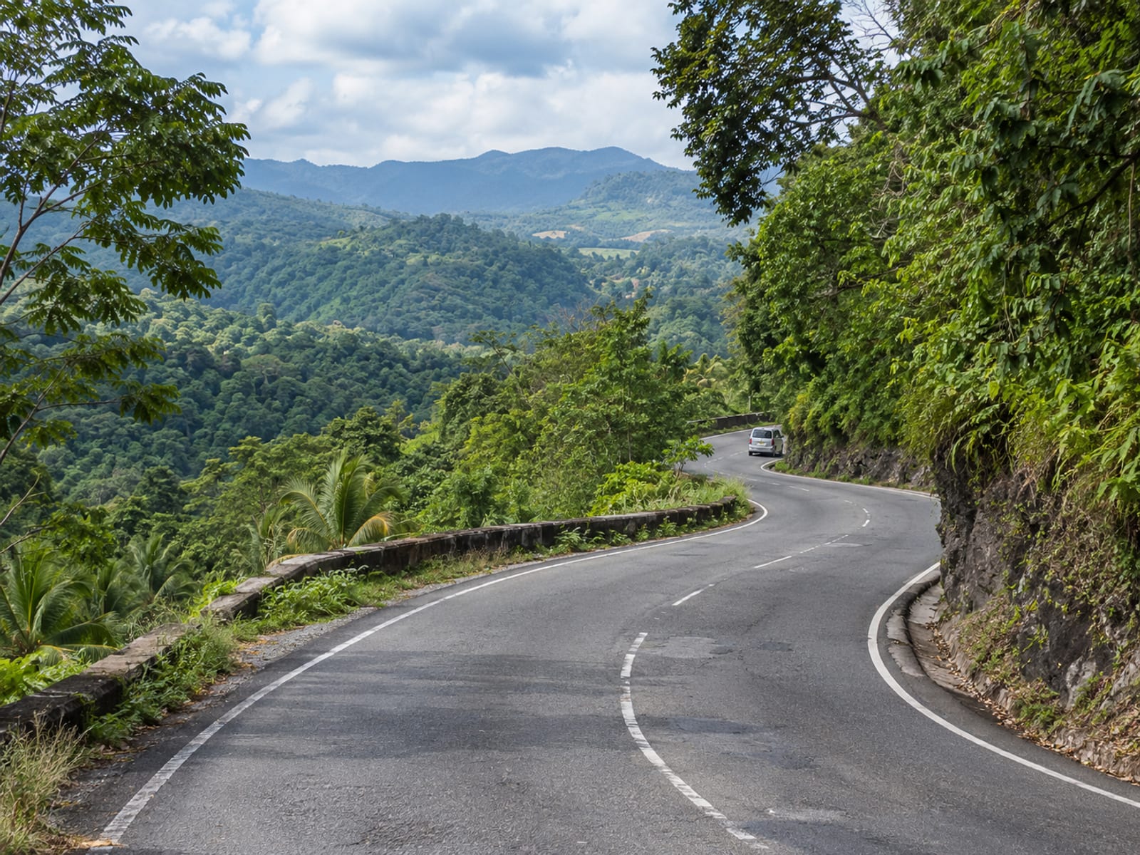 A road through green hills in central Jamaica