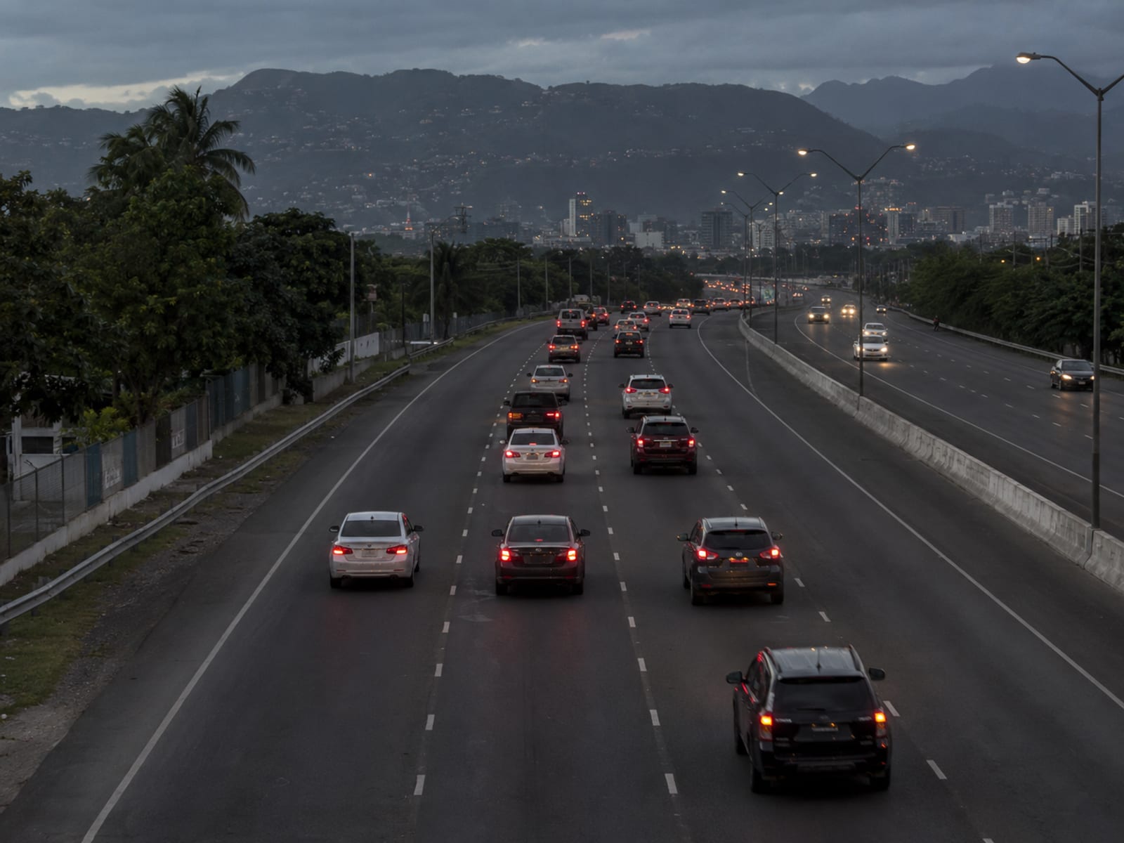 Evening traffic on a multi-lane road into a city