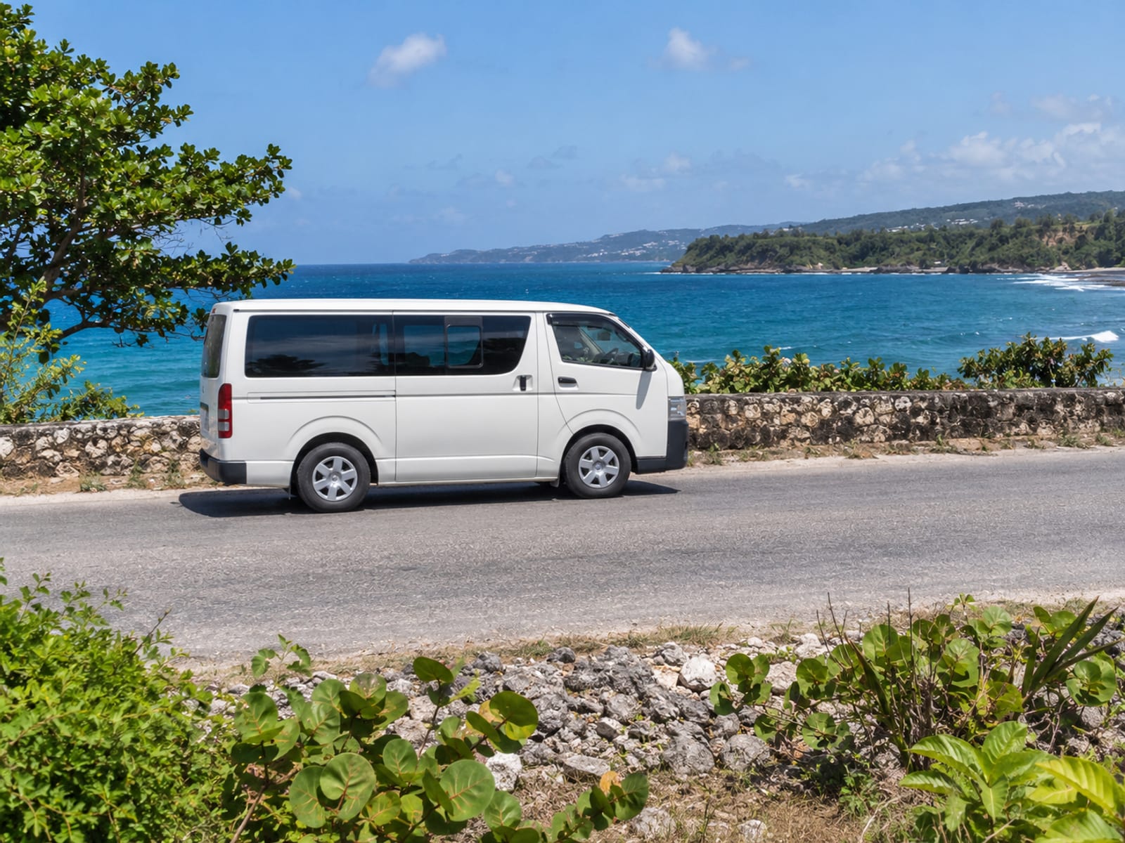 A minivan on a coastal road near Lucea