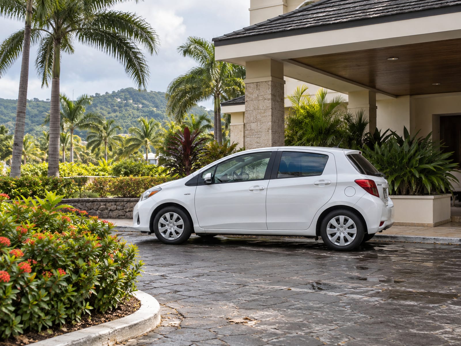 A parked rental car with its doors closed beside a hotel entrance