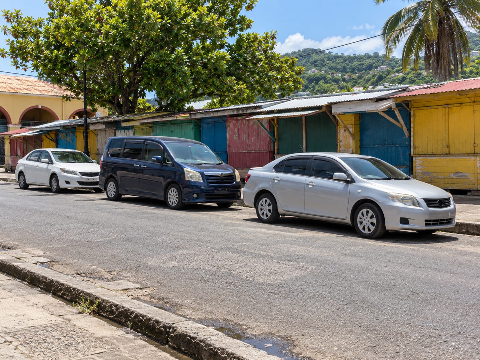 A busy town taxi stand beside a market street