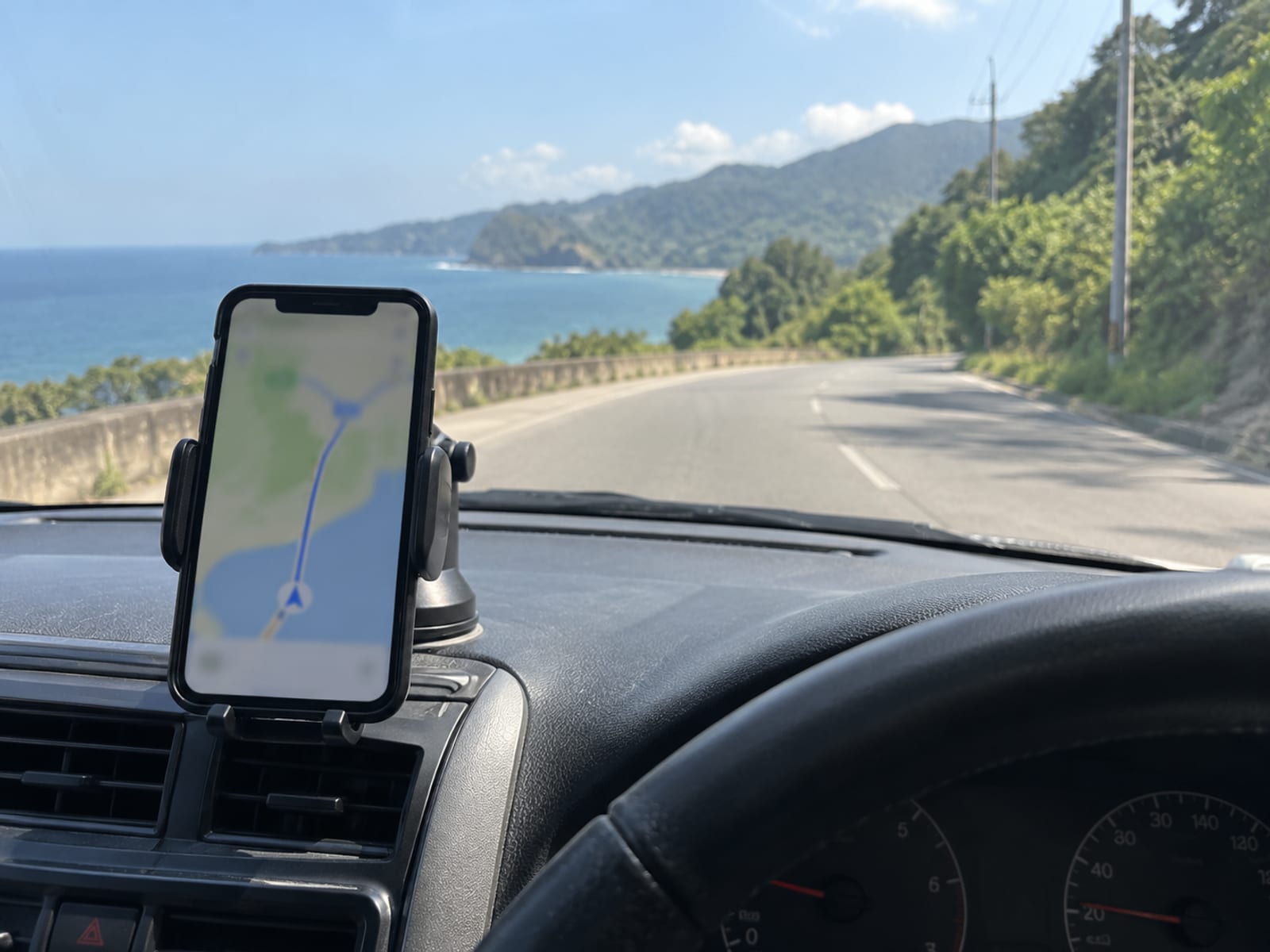 A smartphone showing a map on a car dashboard