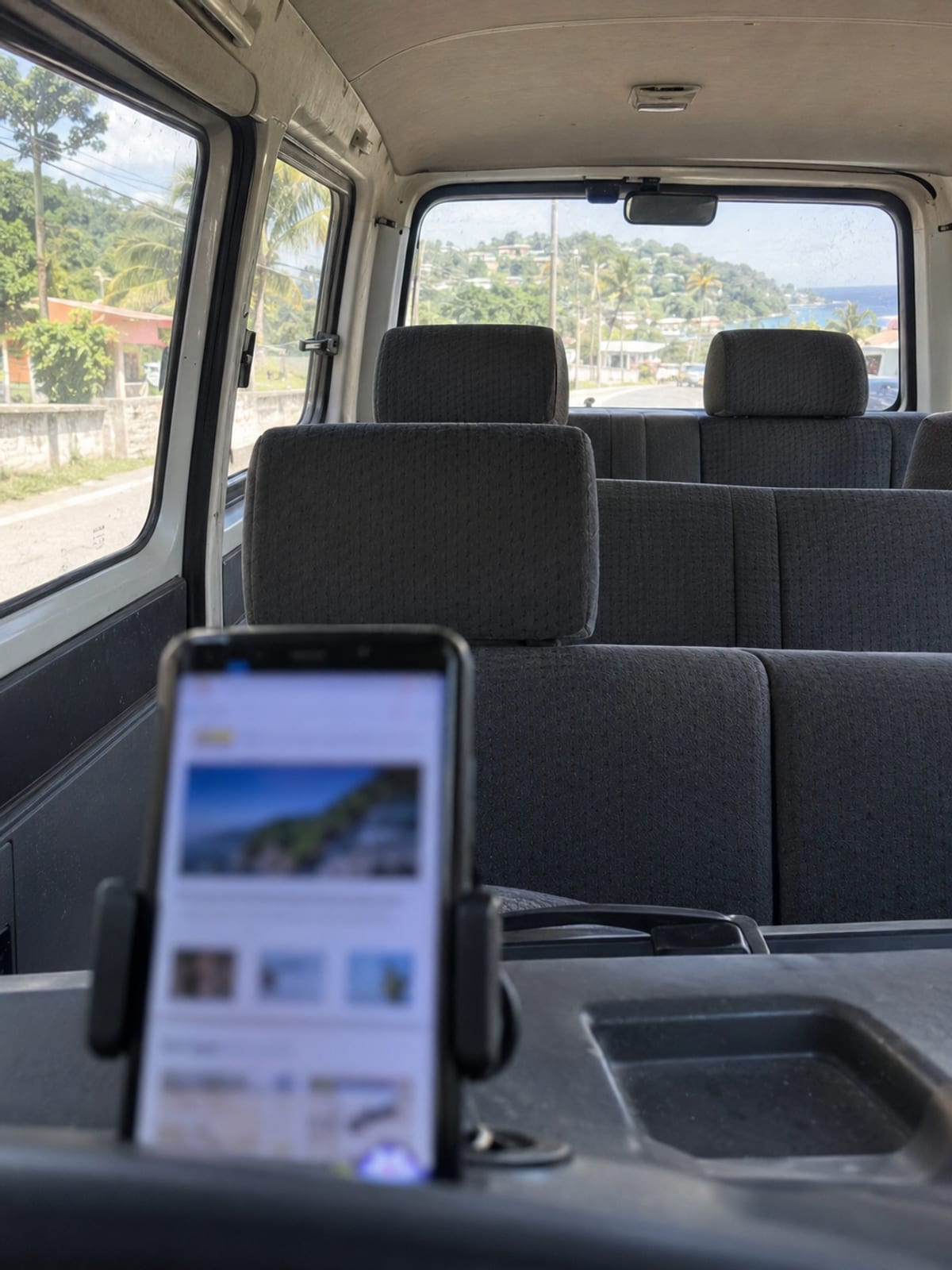A phone in a dashboard mount inside a clean minivan